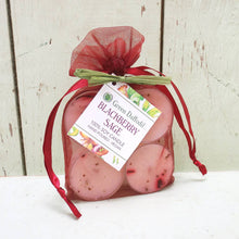 Load image into Gallery viewer, Two pink candles in a red drawstring bag with a label on a white surface.