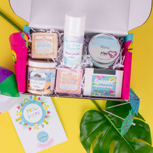 Load image into Gallery viewer, Assorted beauty products in a box with a colorful card on a yellow background