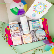 Load image into Gallery viewer, Gift box with beach-themed products including a beach ball on a light green background