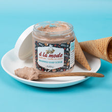 Load image into Gallery viewer, Jar of &#39;a la mode&#39; whipped soap scrub with ice cream-themed packaging on a blue background