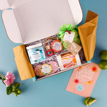 Load image into Gallery viewer, Open gift box with BATH AND BODY items on a blue background
