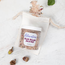 Load image into Gallery viewer, Jar of salt soak blend labeled &#39;Relaxation Salt Soak Blend&#39; on a white fabric bag with decorative elements.