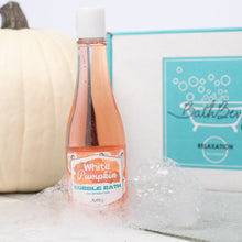 Load image into Gallery viewer, Bottle of &#39;White Pumpkin&#39; bubble bath with a pumpkin and box in the background